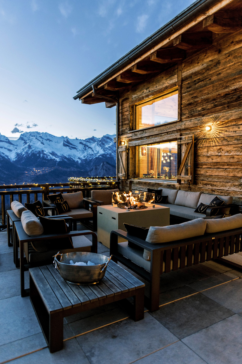 Chalet terrace at dusk with mountain view